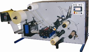 Daco PLD250 tabletop rotary die cutter for the production of plain labels.  The machine is equipped with a single rotary die station, rotary slitting and a semi automatic turret rewinder.